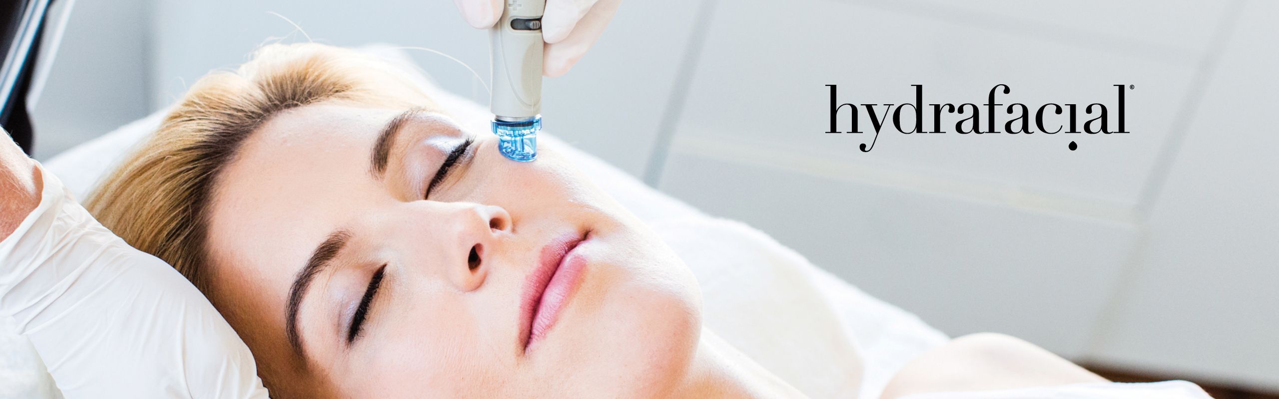 HydraFacial-Behandlung: Handstück gleitet über das Gesicht einer entspannt liegenden Kundin